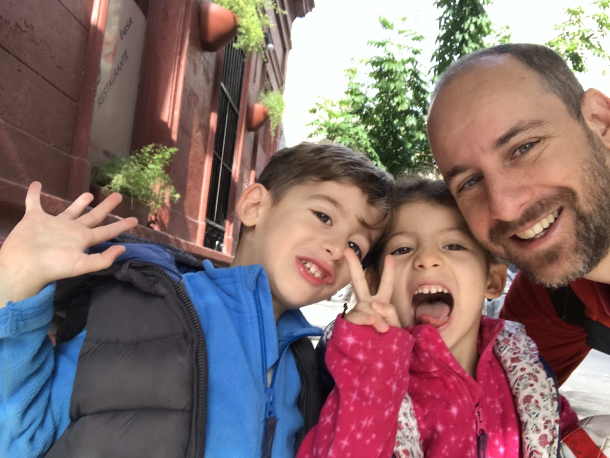 Martin Schurmann smiling in a selfie with his young twins