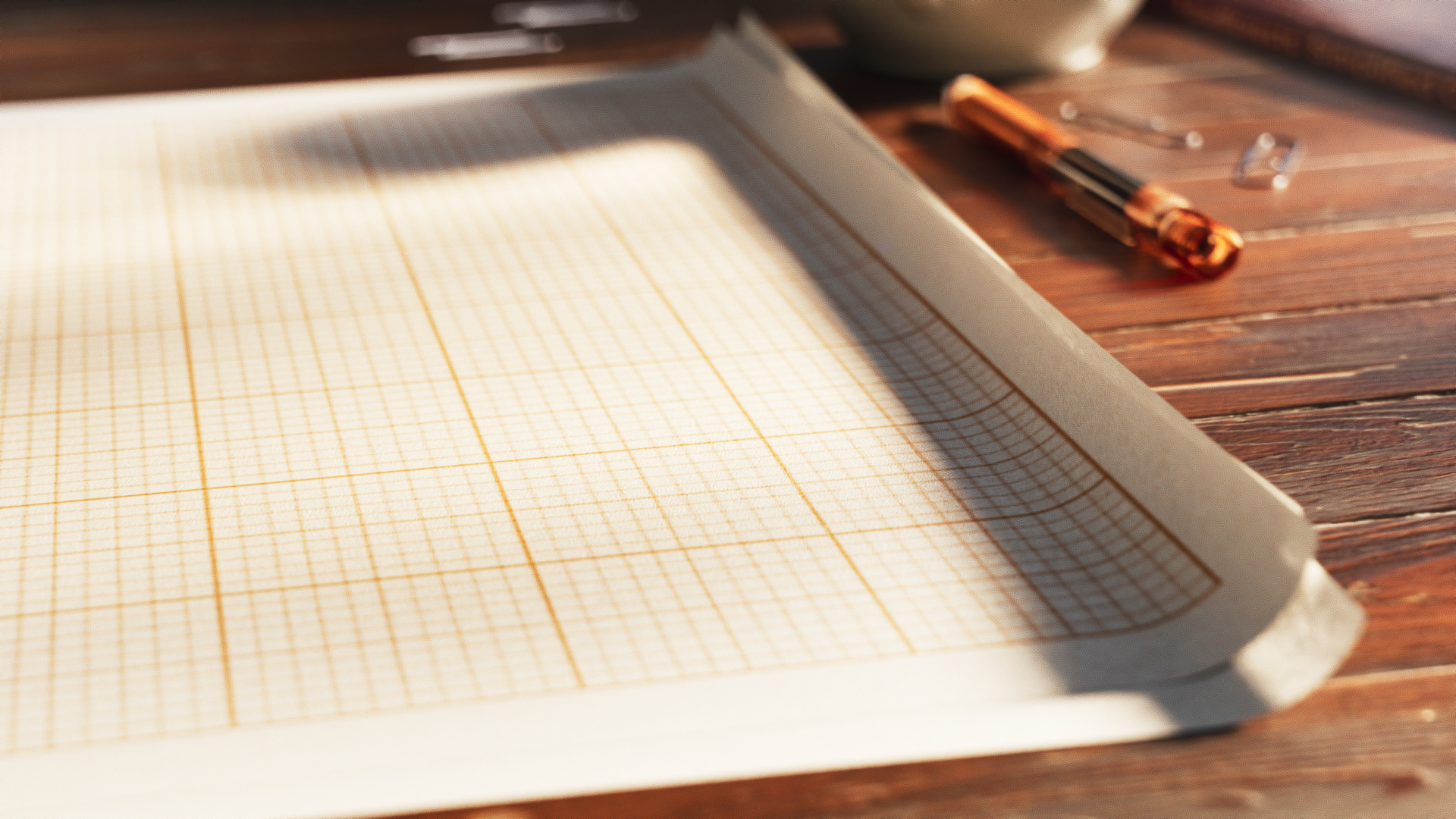 Graph paper and a fountain pen on a sunlit wooden desk in Food Forest – Ketelbroek.